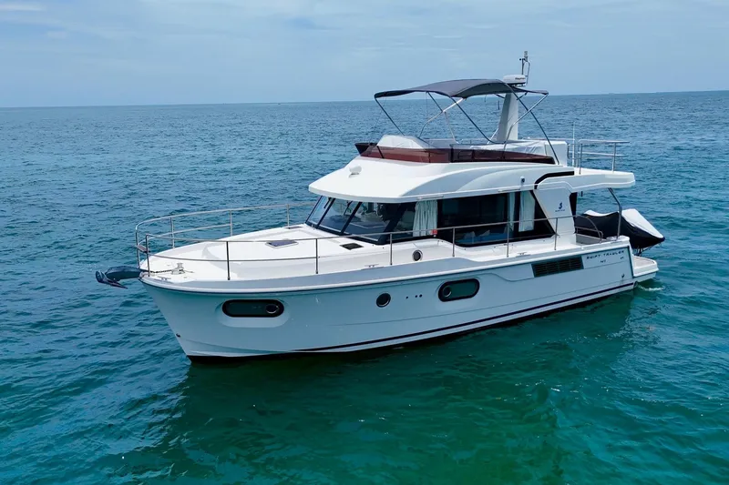 Slide: The Image of 2021 Beneteau Swift Trawler 41 Fly cruising on open sea under clear skies. - 5