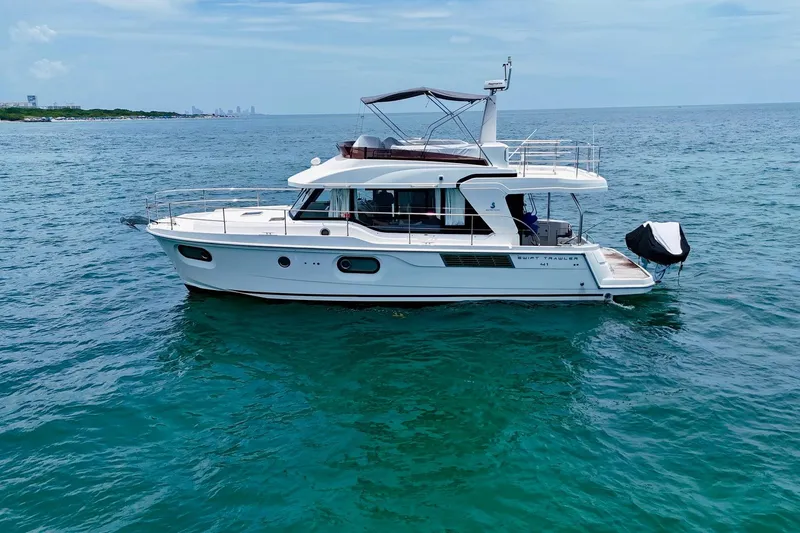 Slide: The Image of 2021 Beneteau Swift Trawler 41 Fly cruising on open sea, side view. - 7