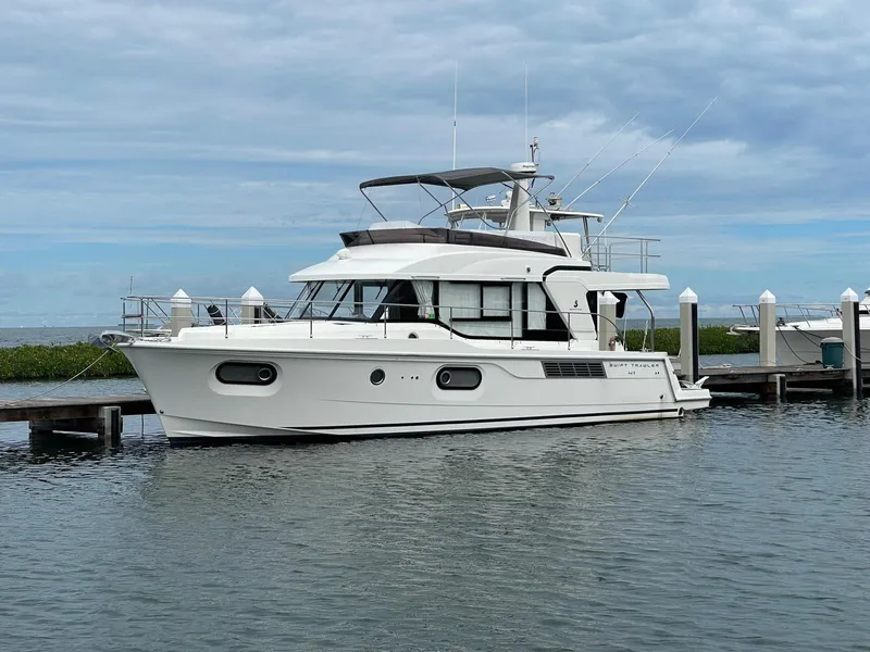 Slide: The Image of 2021 Beneteau Swift Trawler 41 Fly docked at marina under cloudy sky. - 8