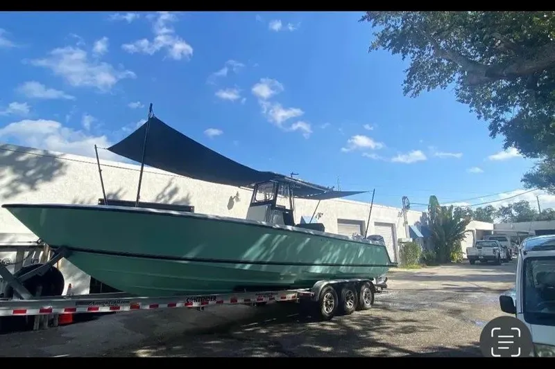 Slide: The Image of 2011 Contender 32 ST boat on trailer under blue sky. - 12