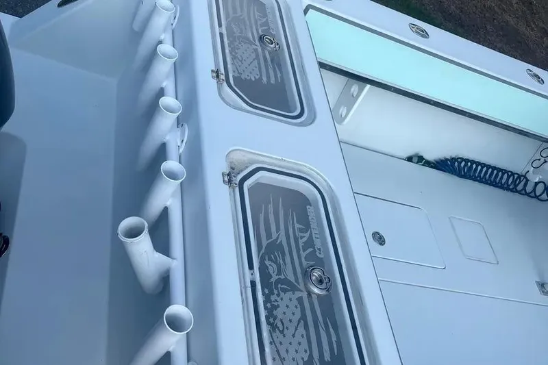 Slide: The Image of 2011 Contender 32 ST boat deck with rod holders and storage compartments. - 4