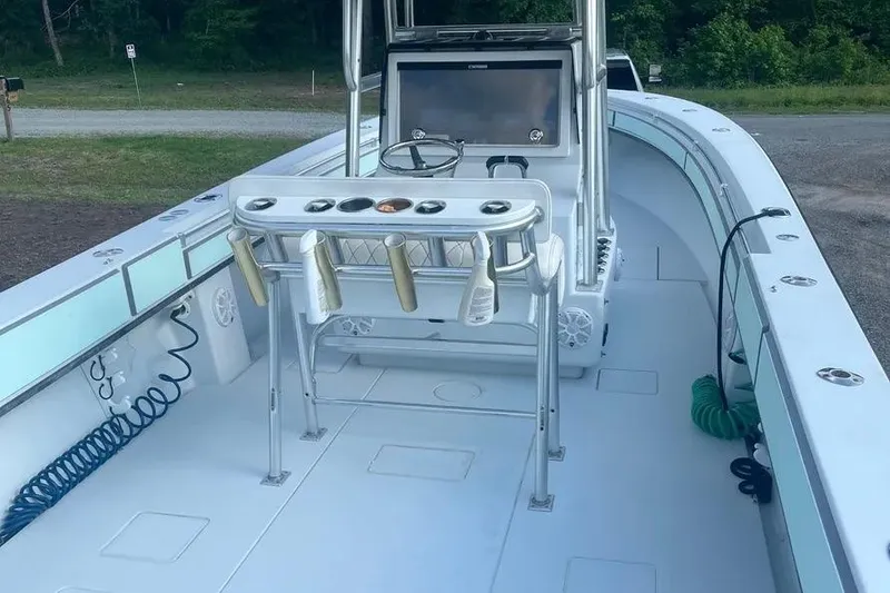 Slide: The Image of 2011 Contender 32 ST boat interior with fishing rod holders and steering console. - 5