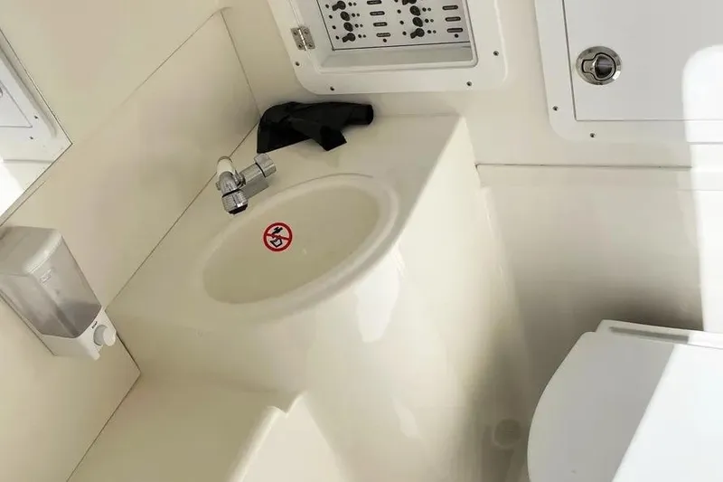 Slide: The Image of 2023 SeaVee 390Z boat bathroom with sink, faucet, and control panel. - 7