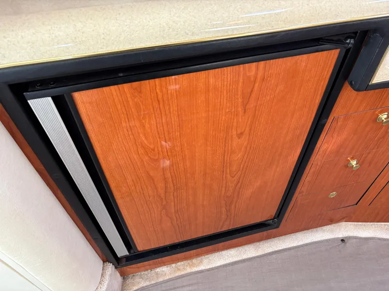 Slide: The Image of Wood-paneled refrigerator in 1999 Sea Ray 340 Sundancer yacht interior. - 27