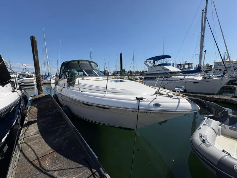 Slide: The Image of 1999 Sea Ray 340 Sundancer docked at marina under clear blue sky. - 3