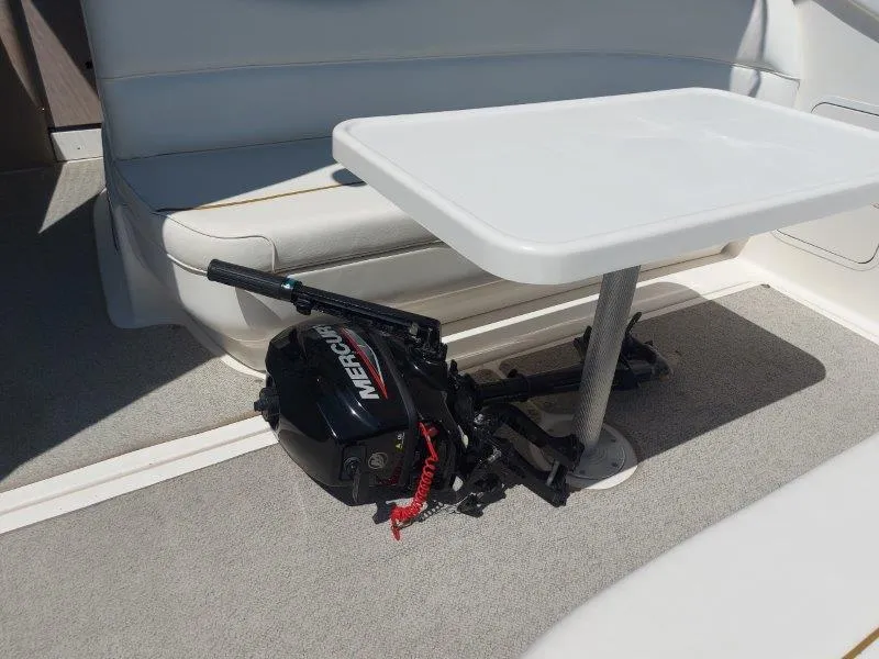 Slide: The Image of 1999 Sea Ray 340 Sundancer interior with table and Mercury outboard motor. - 30