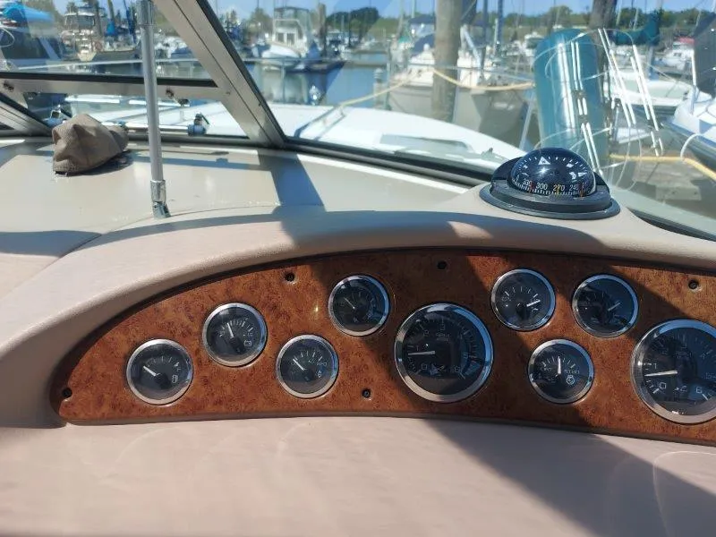 Slide: The Image of Dashboard of a 1999 Sea Ray 340 Sundancer boat with gauges and compass. - 38