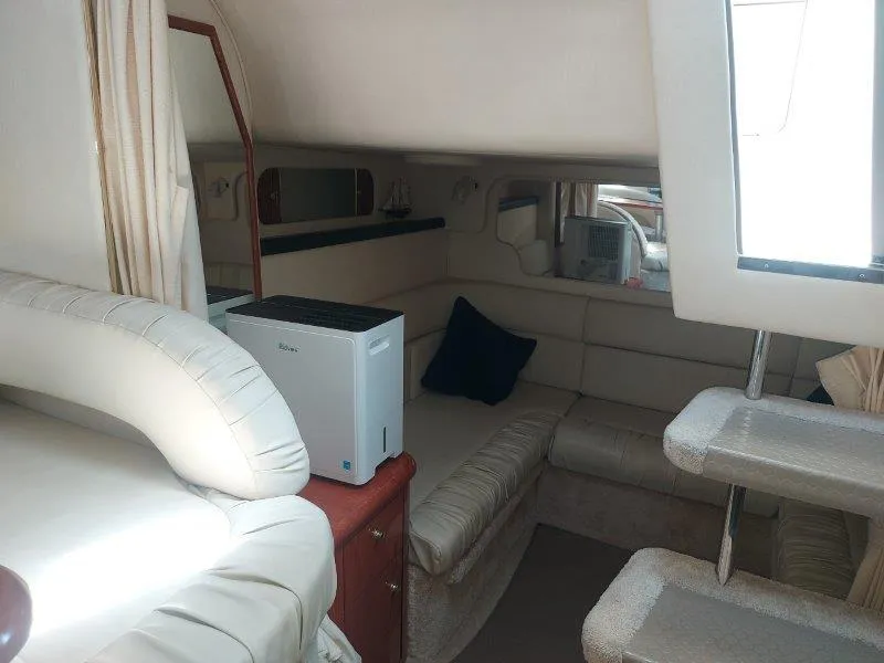 Slide: The Image of Interior of 1999 Sea Ray 340 Sundancer yacht, featuring cozy seating and compact design. - 47