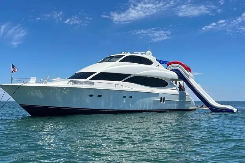The Image of 2004 Lazzara SC Motor Yacht with slide on open water under blue sky. - 1