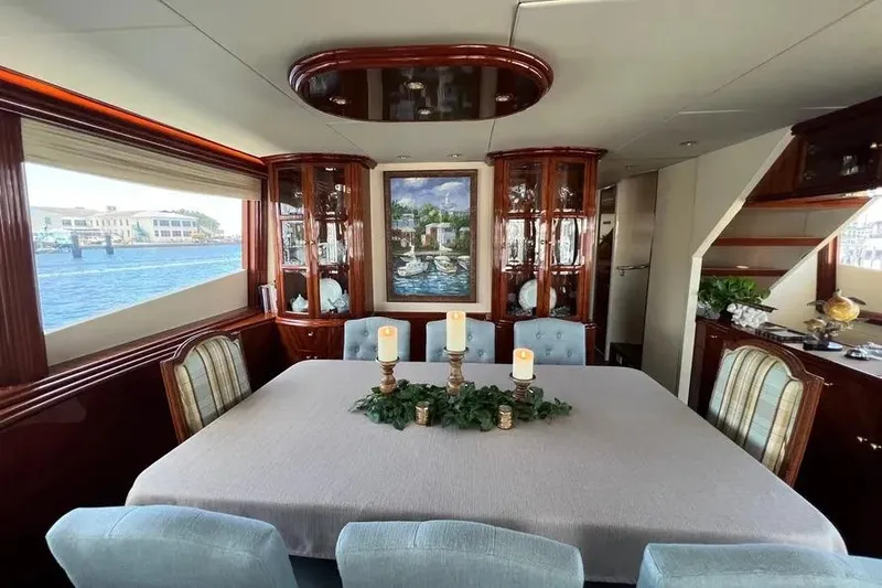 Slide: The Image of Luxurious dining area inside 2004 Lazzara SC Motor Yacht with elegant decor and waterfront view. - 12