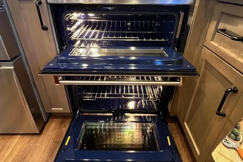 Slide: The Image of Double oven with open doors in a modern kitchen setting. - 19