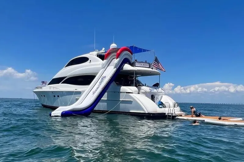 Slide: The Image of 2004 Lazzara SC Motor Yacht with slide, anchored in clear blue waters. - 2