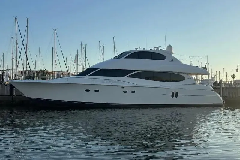 Slide: The Image of 2004 Lazzara SC Motor Yacht docked at marina, sleek design, calm water reflection. - 3