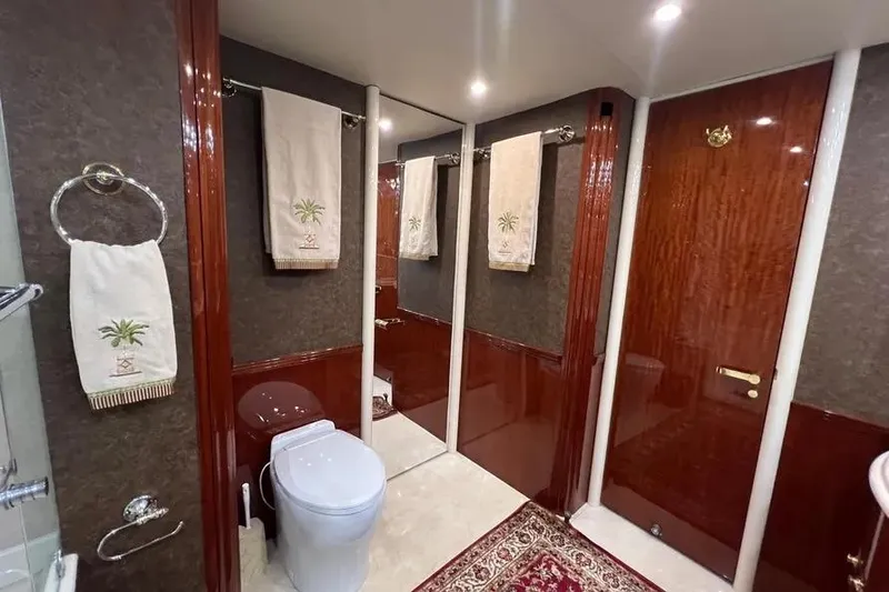 Slide: The Image of Luxurious bathroom in 2004 Lazzara SC Motor Yacht with elegant wood finishes and palm-themed towels. - 34