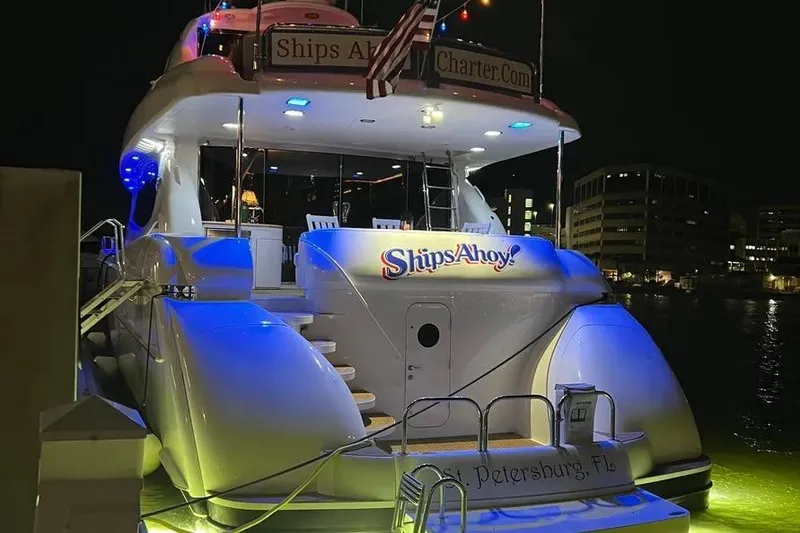 Slide: The Image of 2004 Lazzara SC Motor Yacht docked at night, illuminated with blue lights. - 4