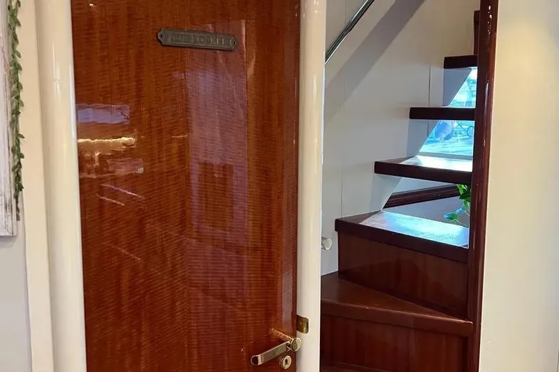 Slide: The Image of Interior of 2004 Lazzara SC Motor Yacht with wooden door and staircase. - 44