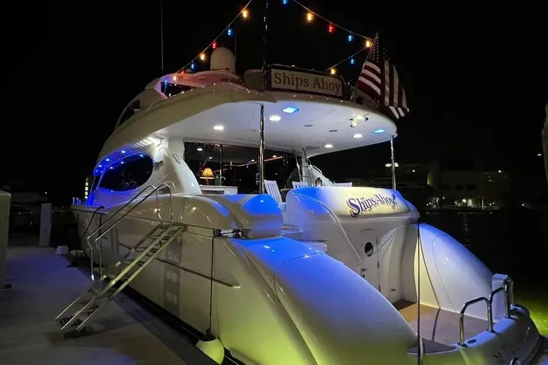 Slide: The Image of 2004 Lazzara SC Motor Yacht at night, illuminated with colorful lights and American flag. - 5