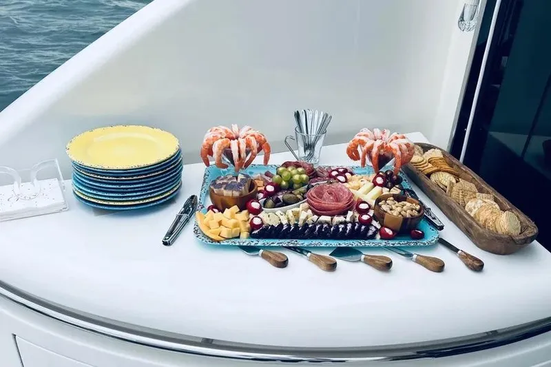 Slide: The Image of Luxurious charcuterie spread on 2004 Lazzara SC Motor Yacht, featuring shrimp, cheese, and crackers. - 58