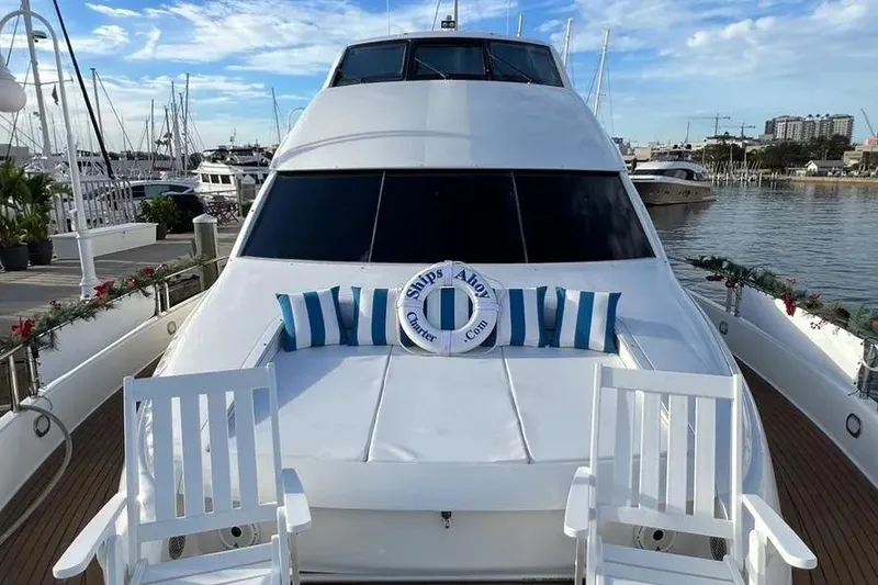 Slide: The Image of 2004 Lazzara SC Motor Yacht docked, featuring striped cushions and a life preserver on deck. - 6