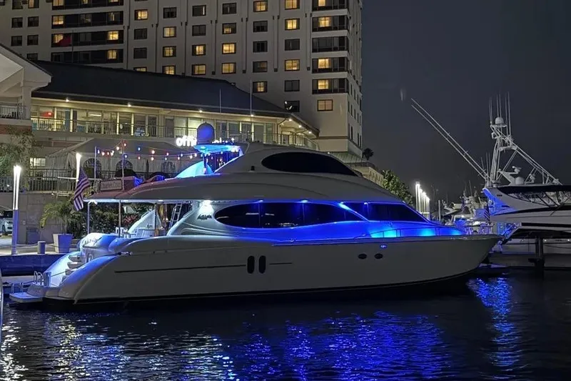 Slide: The Image of 2004 Lazzara SC Motor Yacht illuminated at night in marina, with blue accent lighting. - 60