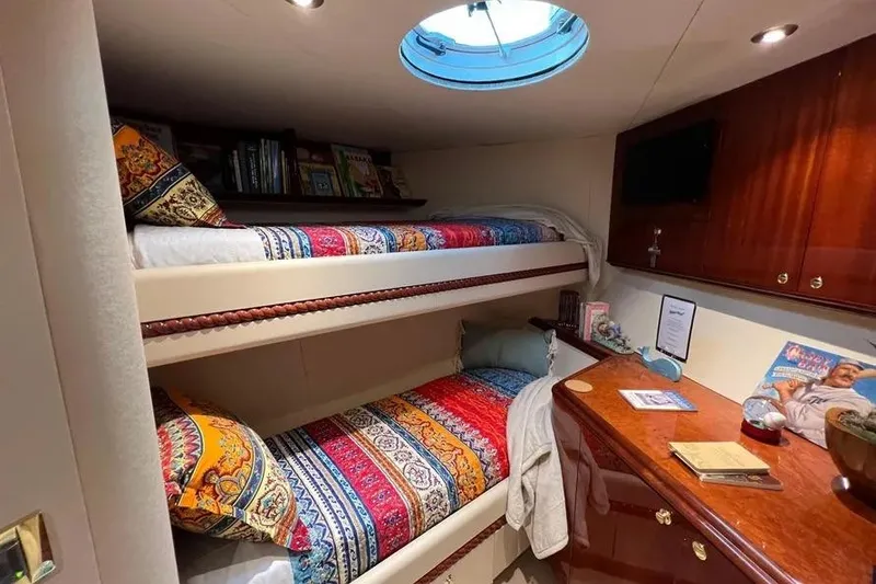 Slide: The Image of Luxurious 2004 Lazzara SC Motor Yacht cabin with colorful bunk beds and elegant wood cabinetry. - 65
