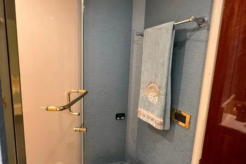 Slide: The Image of Luxurious bathroom in 2004 Lazzara SC Motor Yacht with elegant towel and gold accents. - 68