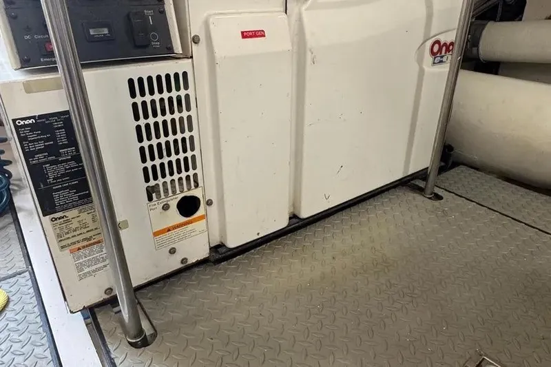 Slide: The Image of Onan generator in 2004 Lazzara SC Motor Yacht engine room, featuring metal flooring. - 74