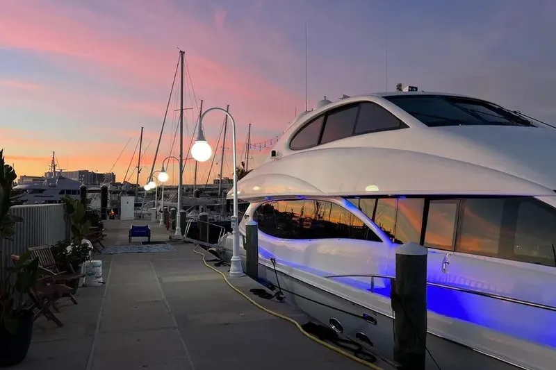 Slide: The Image of 2004 Lazzara SC Motor Yacht docked at sunset with vibrant sky. - 79