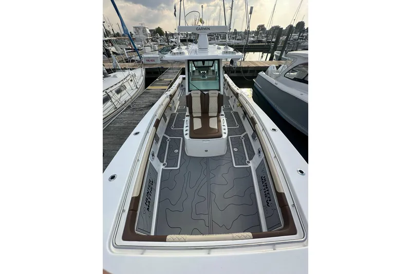 Slide: The Image of 2024 Caymas 34 CT boat docked, featuring sleek design and spacious deck layout. - 12