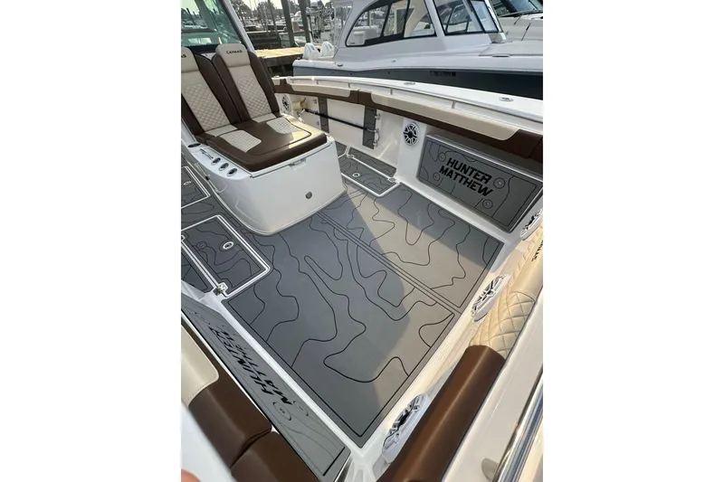 Slide: The Image of 2024 Caymas 34 CT boat interior with custom flooring and seating. - 14