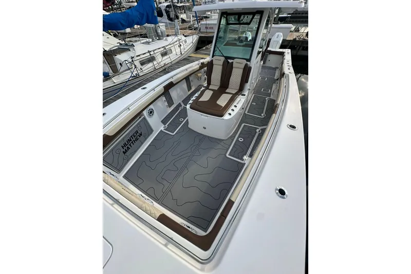 Slide: The Image of 2024 Caymas 34 CT boat with sleek deck design and comfortable seating. - 15