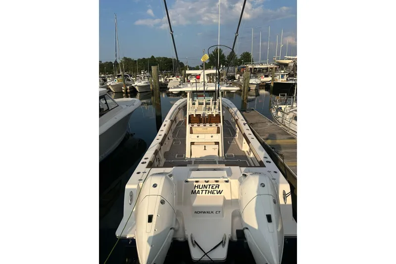 Slide: The Image of 2024 Caymas 34 CT boat docked at marina with twin engines. - 17