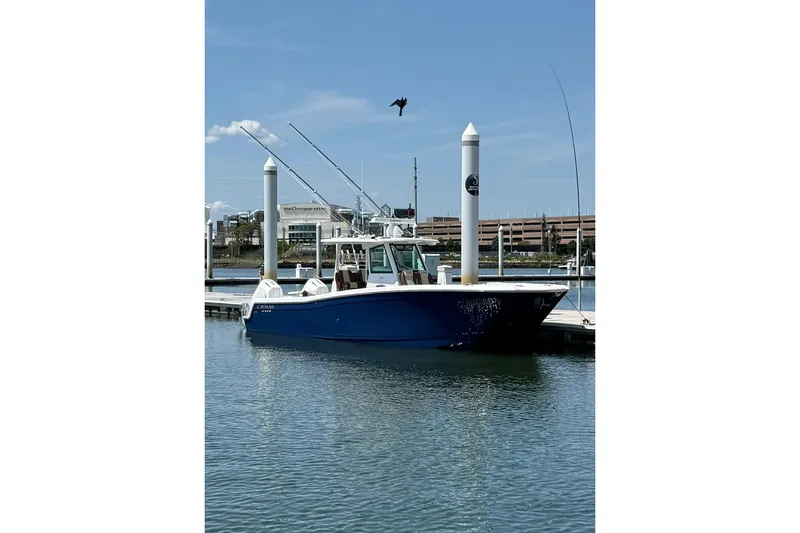 Slide: The Image of 2024 Caymas 34 CT boat docked in marina under clear blue sky. - 2