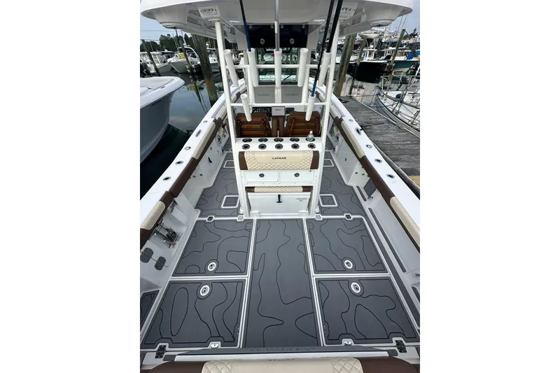 Slide: The Image of 2024 Caymas 34 CT boat interior with sleek gray deck and fishing rod holders. - 7