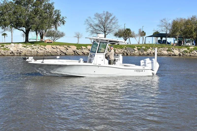 Slide: The Image of 2024 Caymas 281 HB boat cruising on a calm river with scenic background. - 1