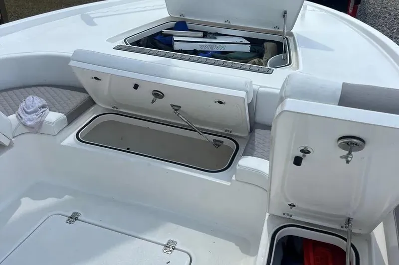 Slide: The Image of 2024 Caymas 281 HB boat storage compartments and seating area. - 10