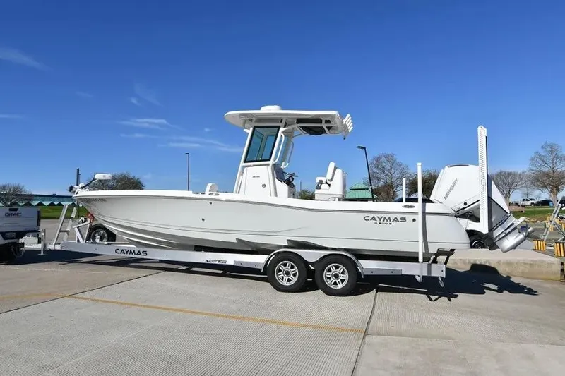 Slide: The Image of 2024 Caymas 281 HB boat on trailer under clear blue sky. - 3