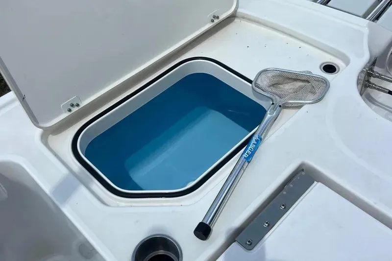 Slide: The Image of 2024 Caymas 281 HB boat livewell with a fishing net on deck. - 7