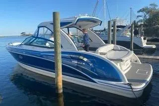 The Image of 2018 Formula 350 Crossover Bowrider in marina, blue and white design, sunny day. - 1