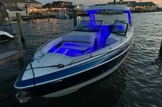 Slide: The Image of 2018 Formula 350 Crossover Bowrider with blue interior lighting docked at sunset. - 14