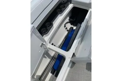 Slide: The Image of 2018 Formula 350 Crossover Bowrider storage compartment with organized interior and cup holders. - 16