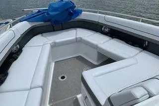 Slide: The Image of 2018 Formula 350 Crossover Bowrider with spacious seating on a calm water backdrop. - 22