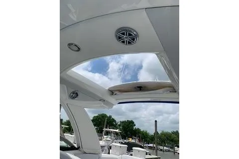 Slide: The Image of 2018 Formula 350 Crossover Bowrider interior with open sunroof and speakers, docked at marina. - 26