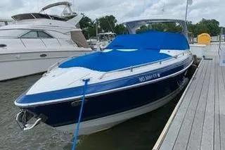 Slide: The Image of 2018 Formula 350 Crossover Bowrider docked, featuring a blue cover and sleek design. - 3