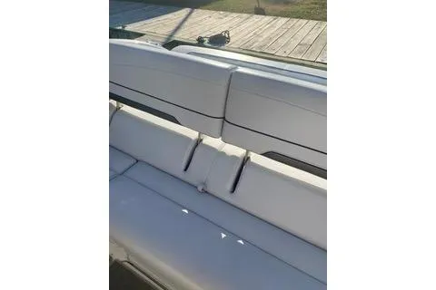 Slide: The Image of 2018 Formula 350 Crossover Bowrider, white seating detail, docked outdoors. - 8