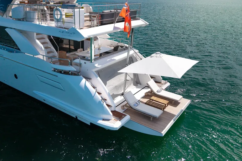 Slide: The Image of Luxurious 2022 Azimut Grande 27 METRI yacht with sun loungers and umbrella on deck. - 10
