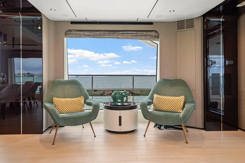 Slide: The Image of Luxurious Azimut Grande 27 METRI yacht interior with ocean view, featuring stylish seating and decor. - 105