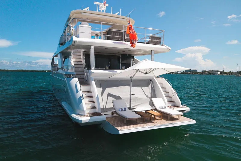 Slide: The Image of Luxurious 2022 Azimut Grande 27 METRI yacht with sun loungers and umbrella on deck. - 11