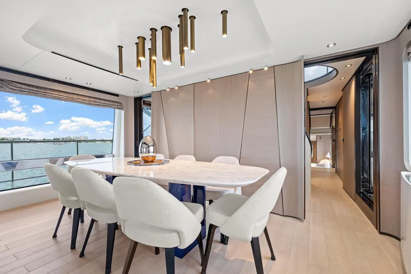 Slide: The Image of Luxurious dining area on 2022 Azimut Grande 27 METRI yacht with elegant decor and sea view. - 113