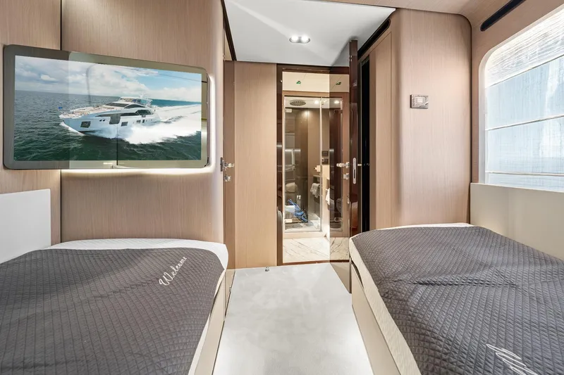 Slide: The Image of Luxurious interior of 2022 Azimut Grande 27 METRI yacht with twin beds and modern decor. - 116